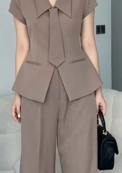 Brown coord set with a single-breasted blazer and flared pants with tie.