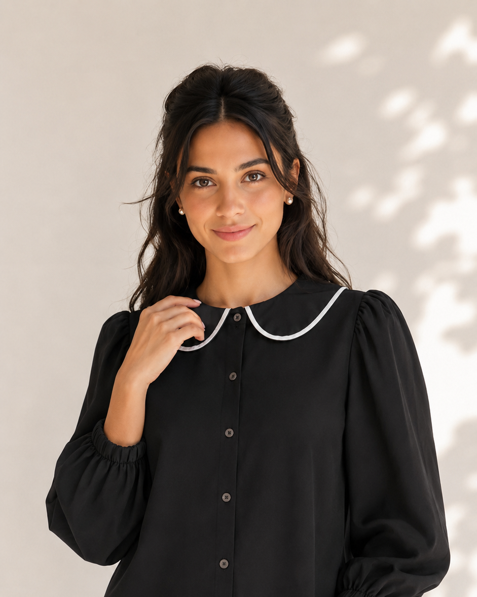 Black button-front shirt with white-trimmed round collar and voluminous sleeves, close-up front view | Beyond Formals