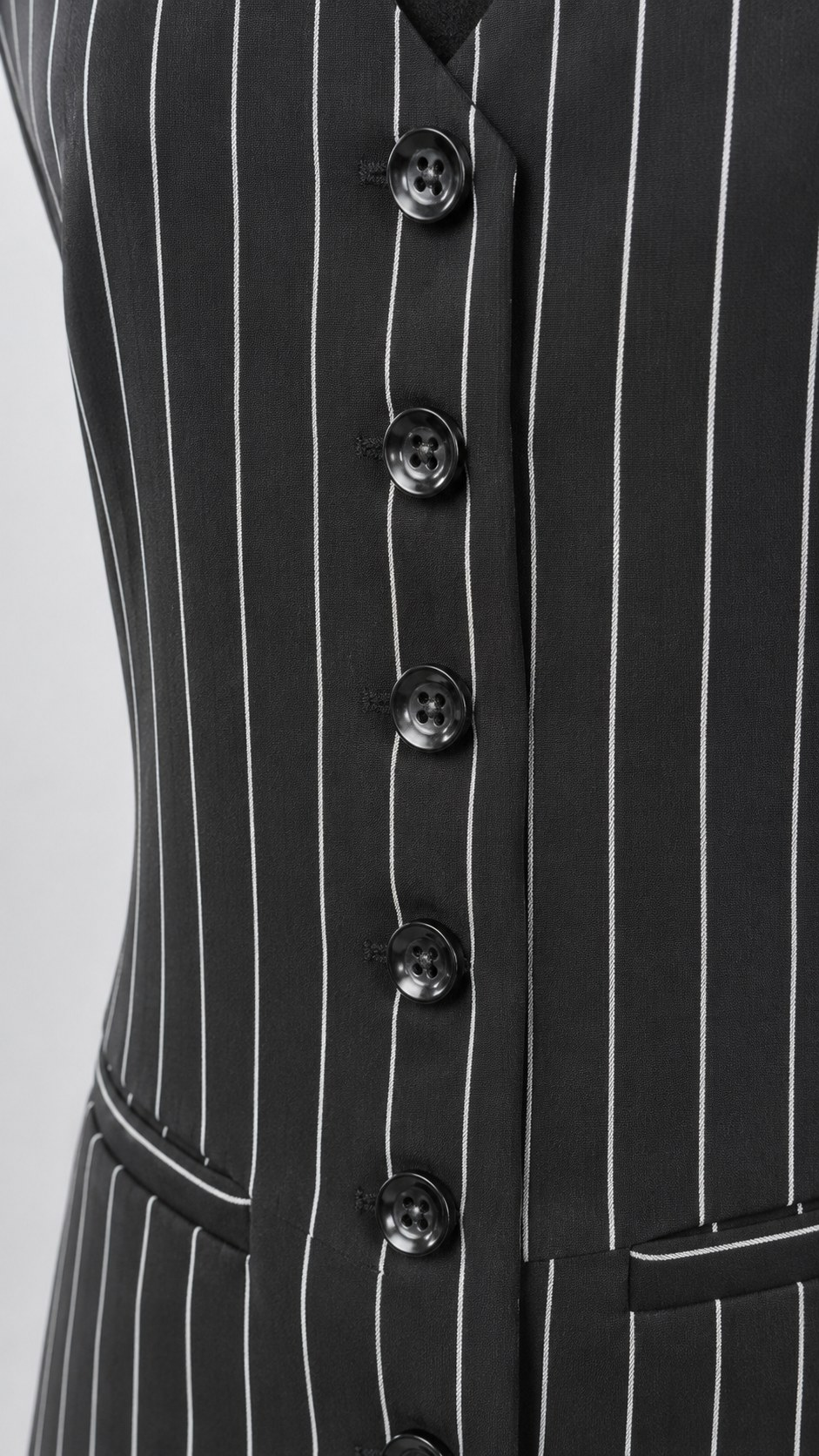 Black pinstripe waistcoat, detail of black buttons, pointed hem and welt pocket | Beyond Formals