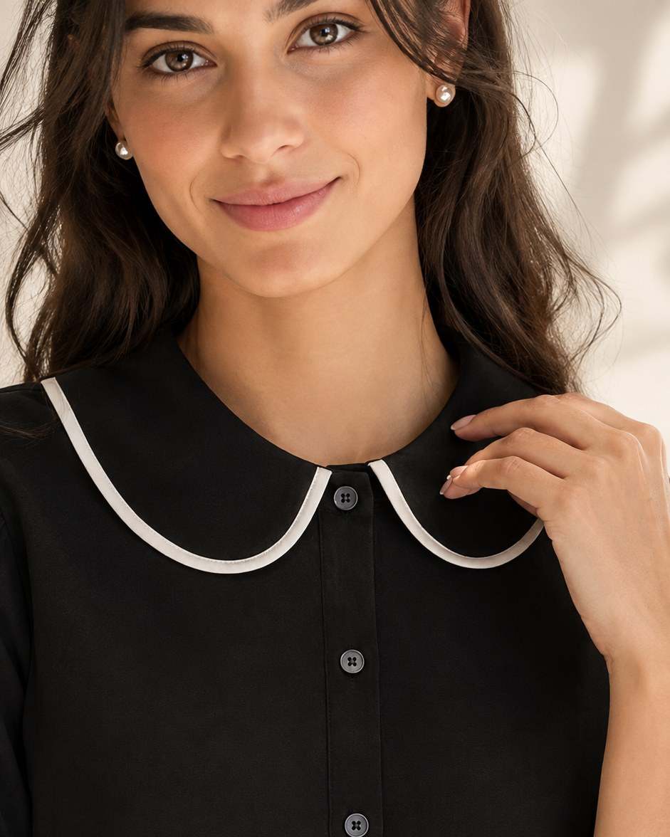 Black shirt close-up of white-piped rounded collar, button placket and elasticated cuff | Beyond Formals