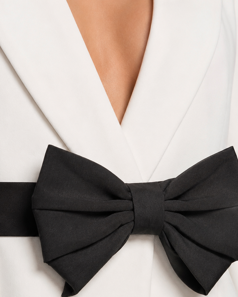 Close-up of the black layered bow sash on the white blazer | Beyond Formals