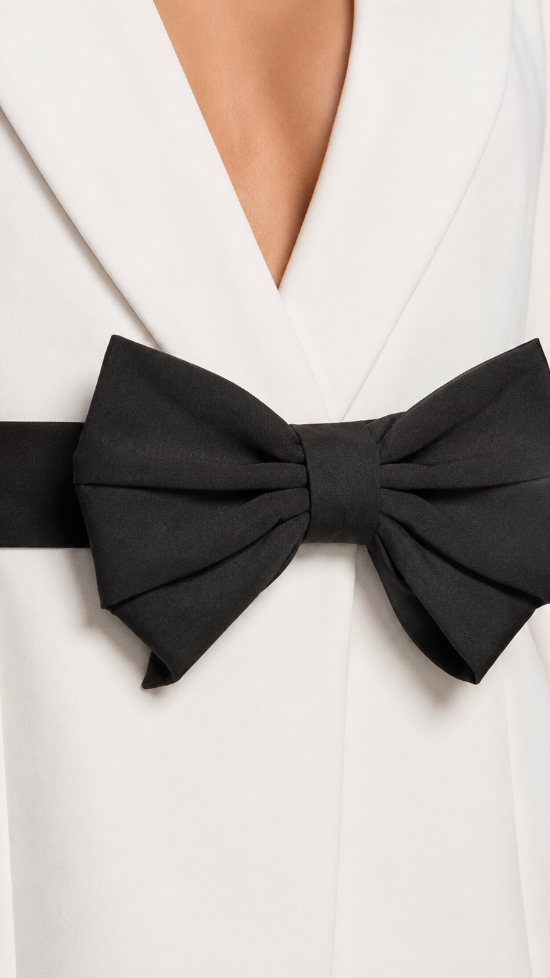 White blazer with a large black bow tie
