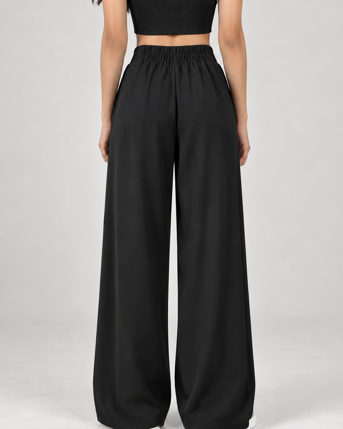Black wide-leg formal trousers, back view showing elasticated waistband | Beyond Formals