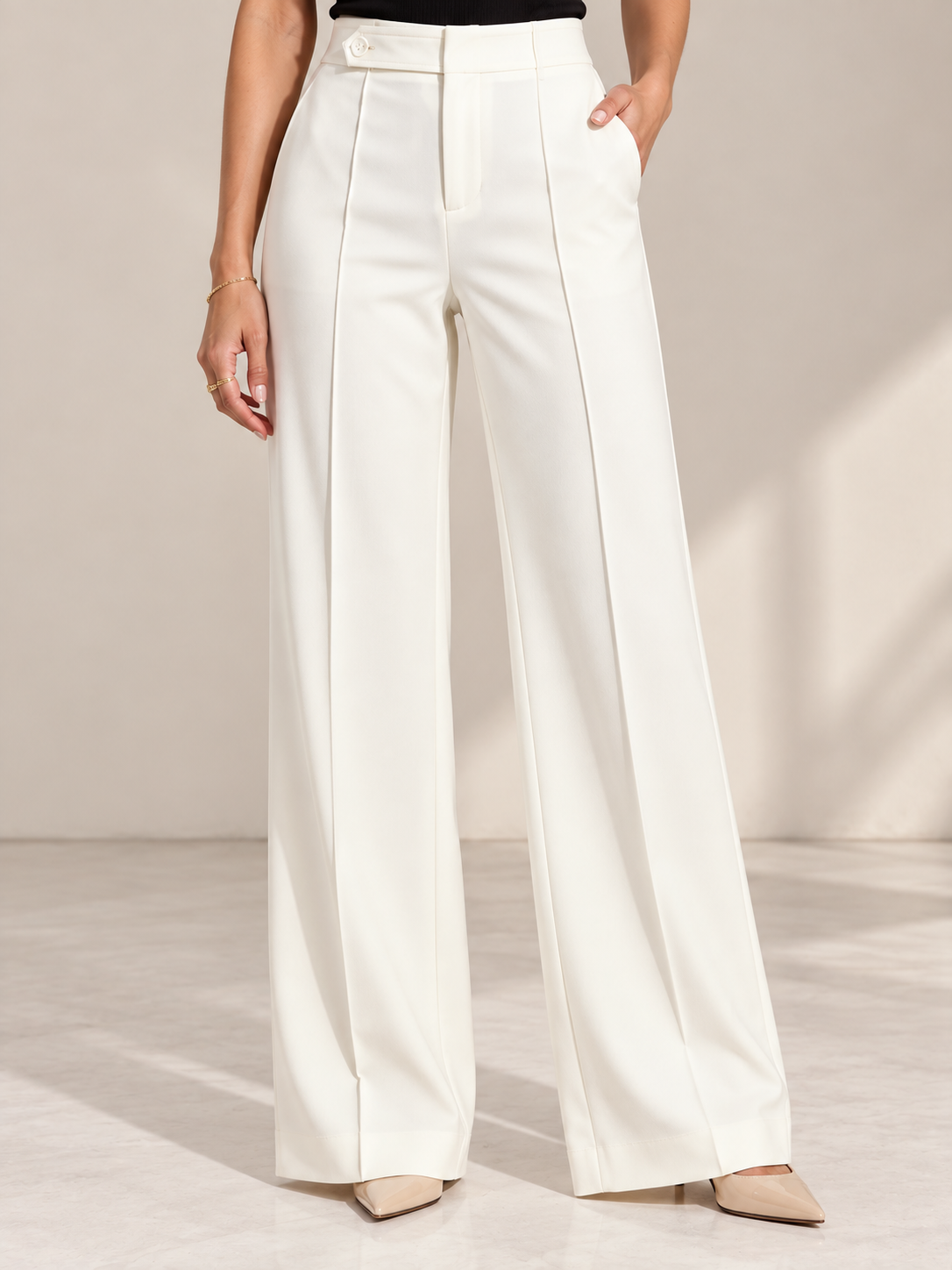 Off-white ultra high-waist trousers close-up of button tab waistband and front seam | Beyond Formals