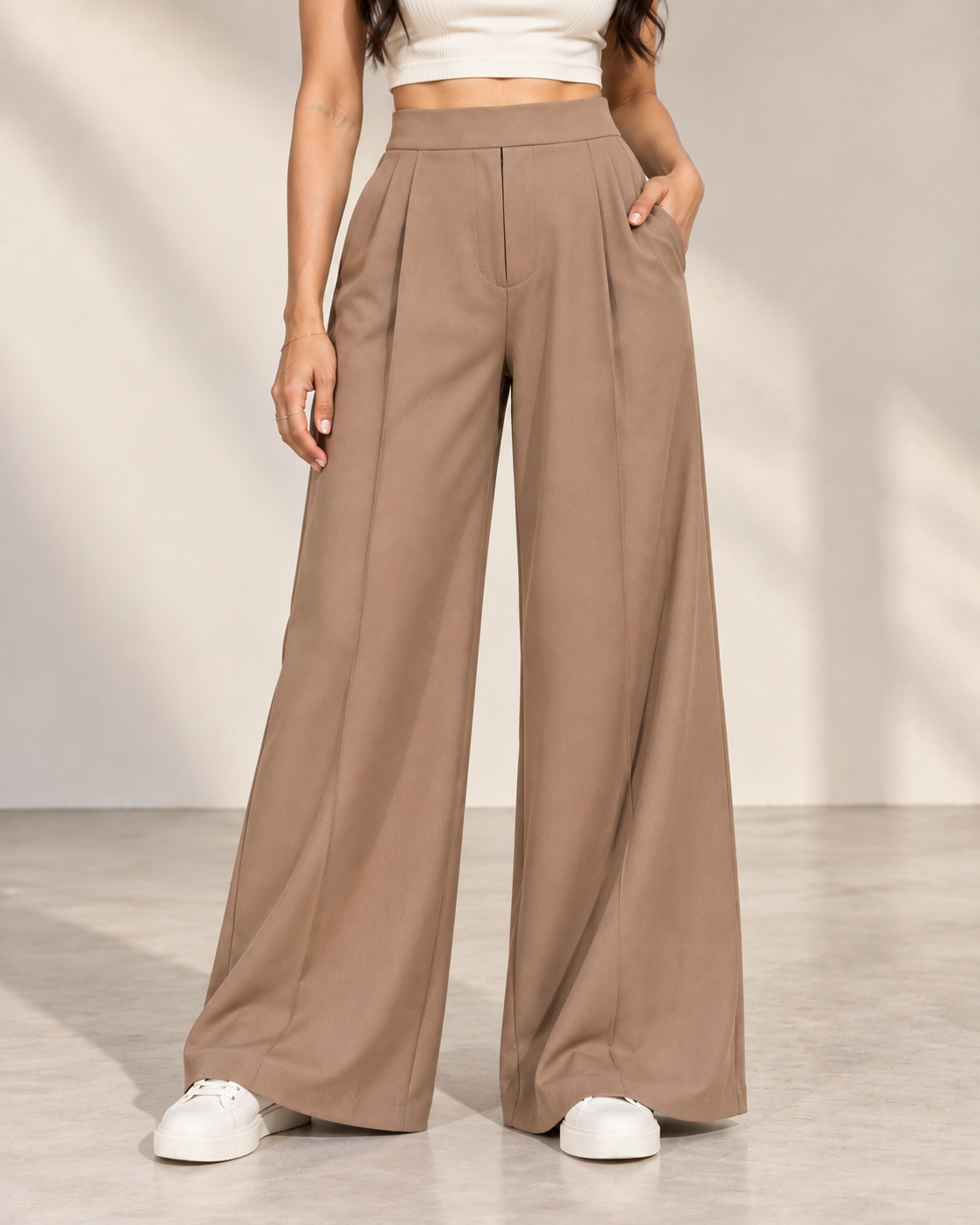 Beige wide-leg trousers close-up of high waistband, front pleats and side pockets | Beyond Formals