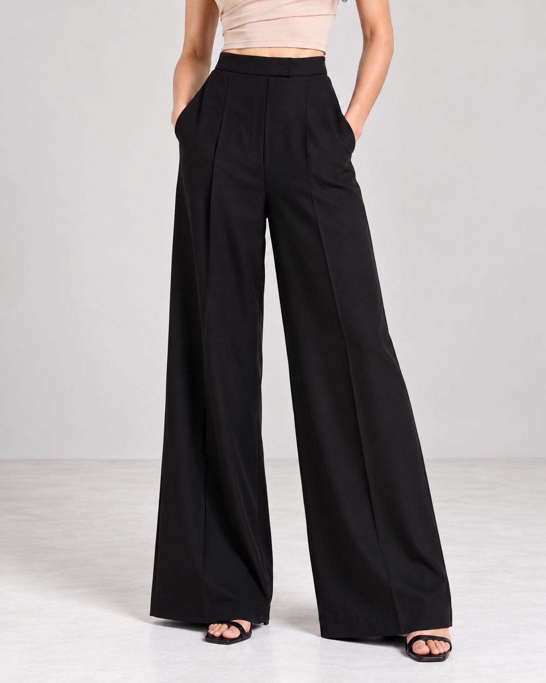 Black wide-leg trousers, close-up of high waistband, front pleats and centre crease | Beyond Formals