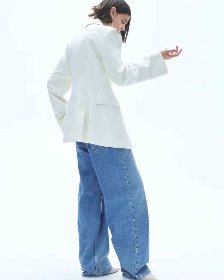 Women's white blazer with padded shoulders and a tailored fit.