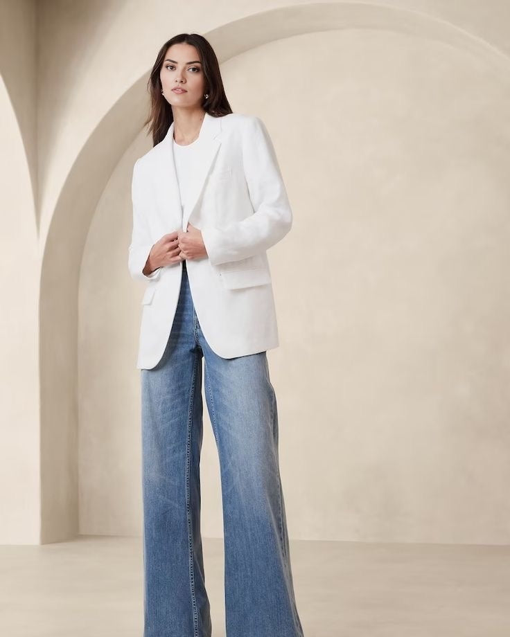 Women's white blazer with padded shoulders and a tailored fit.