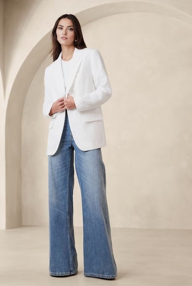 Women's white blazer with padded shoulders and a tailored fit.