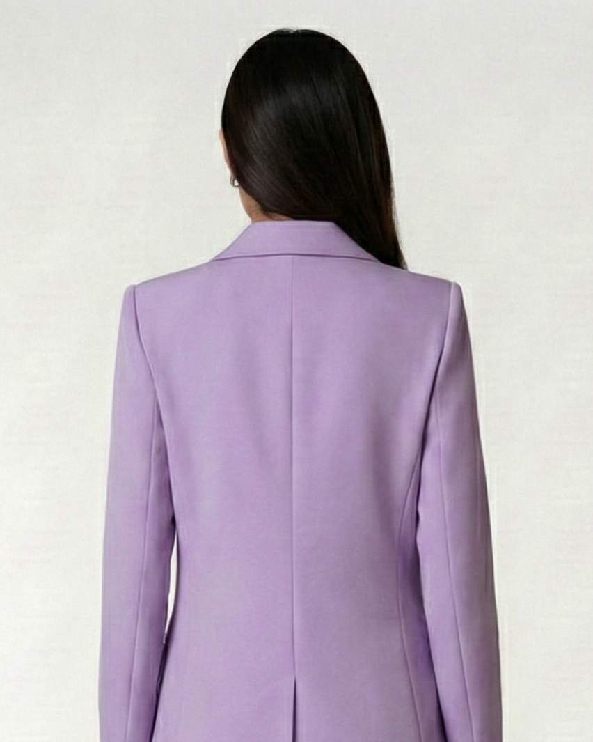 Person wearing a lavender suit on a white background