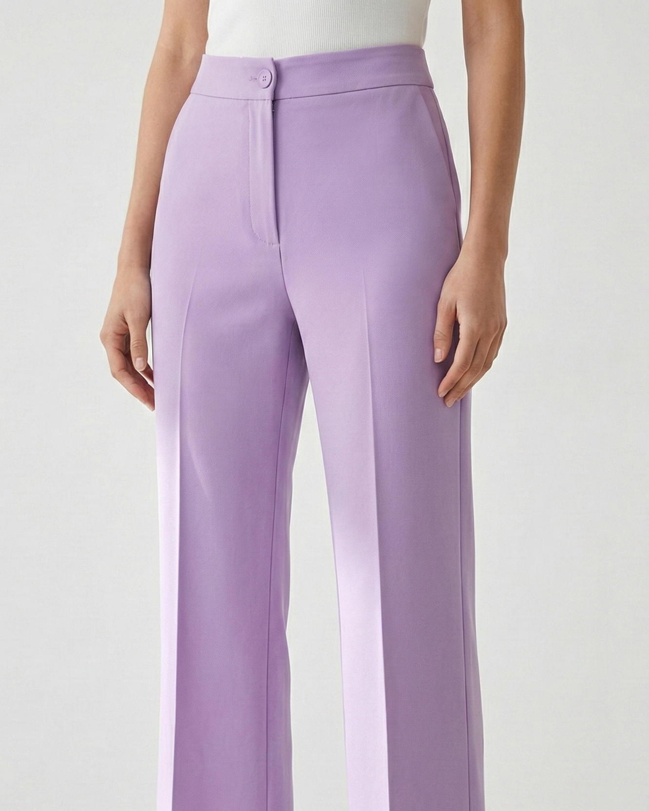 Person wearing lavender wide-leg pants on a white background