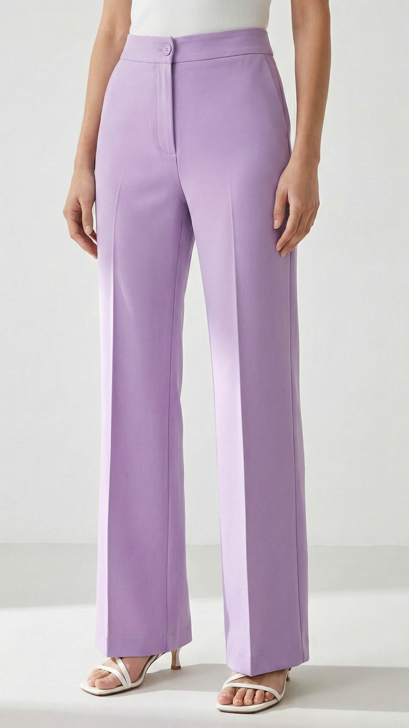 Person wearing lavender wide-leg pants on a white background