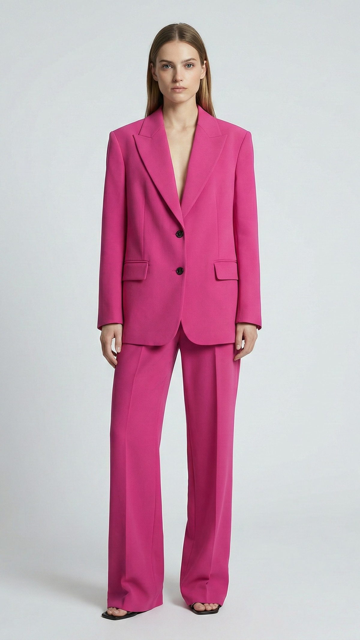 Hot Pink two-button blazer suit set with peak lapels on model, full-length front view | Beyond Formals