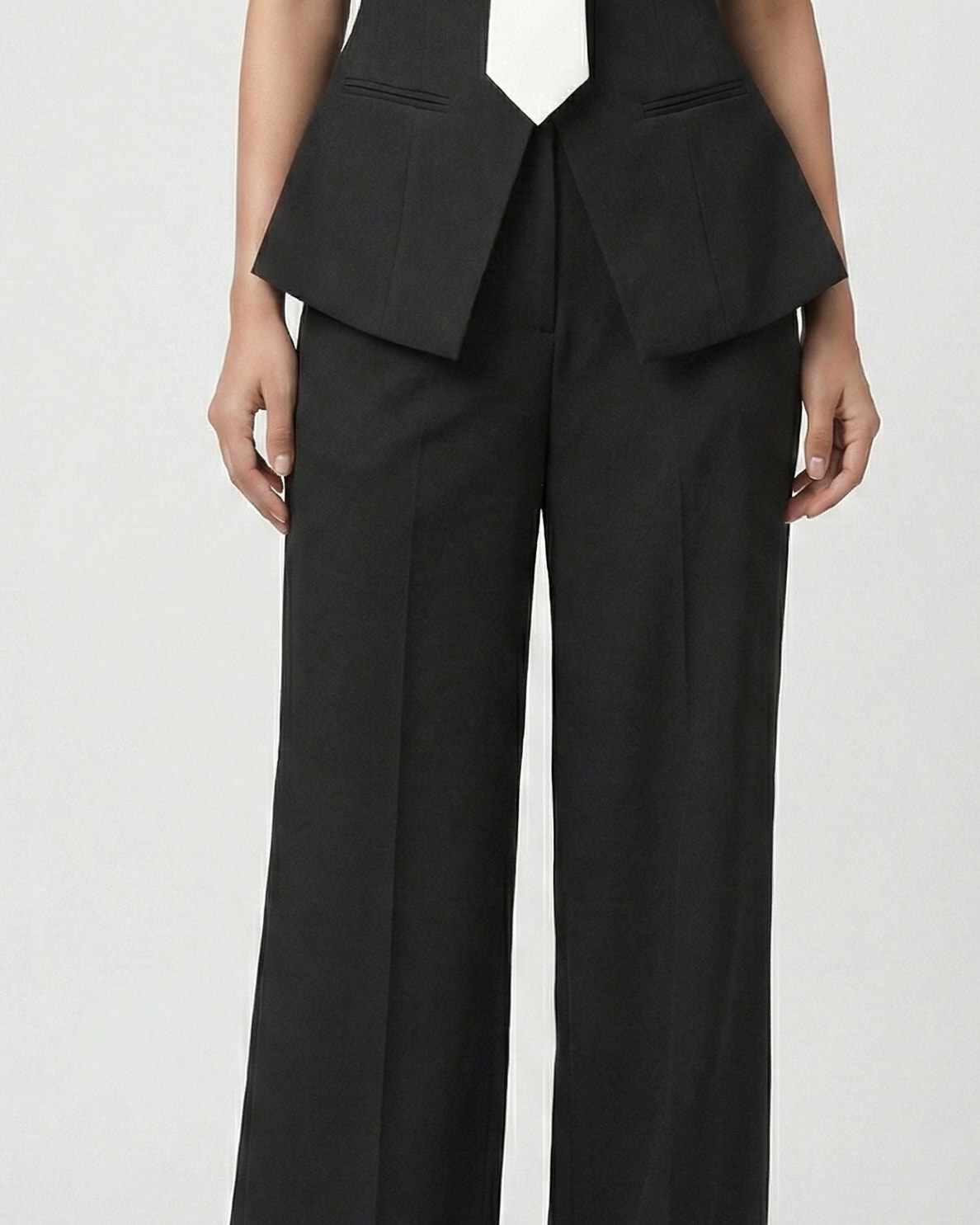 Black high-waisted wide-leg trousers with pointed peplum blazer hem, lower-body view | Beyond Formals