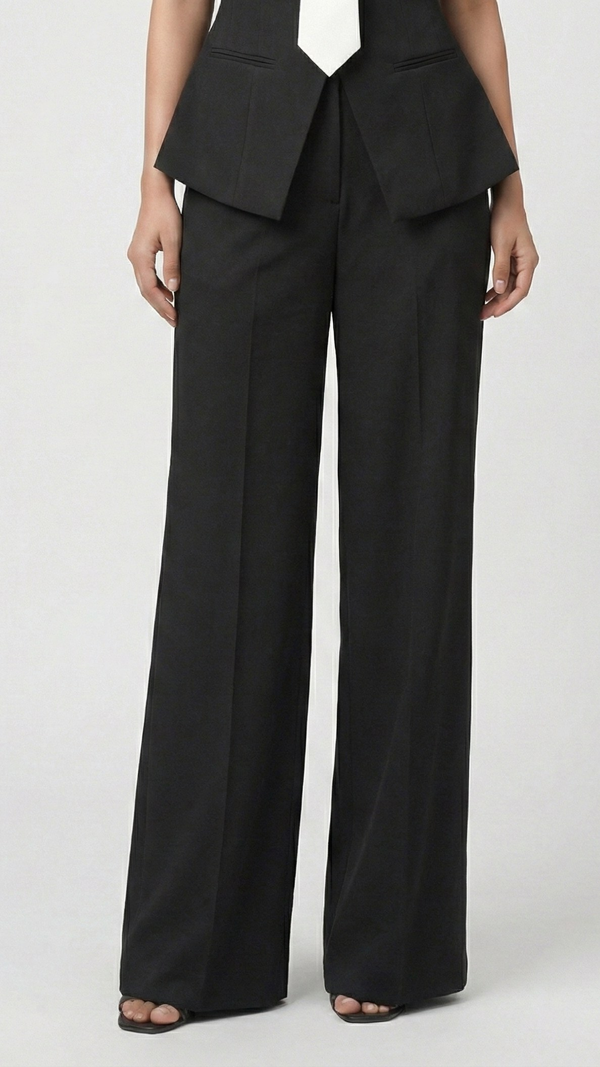 Black high-waisted wide-leg trousers with pointed peplum blazer hem, lower-body view | Beyond Formals
