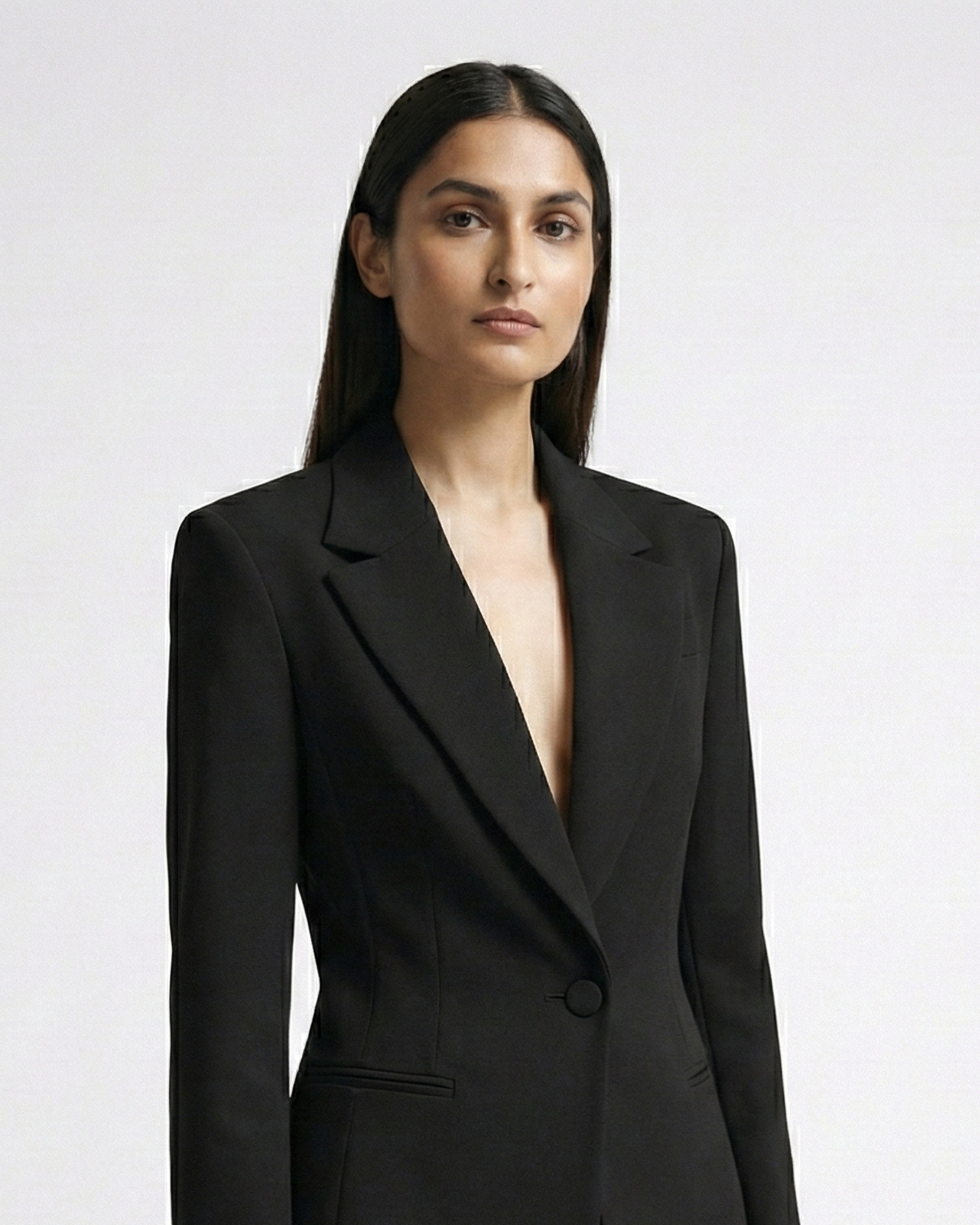 Woman wearing a black suit on a white background