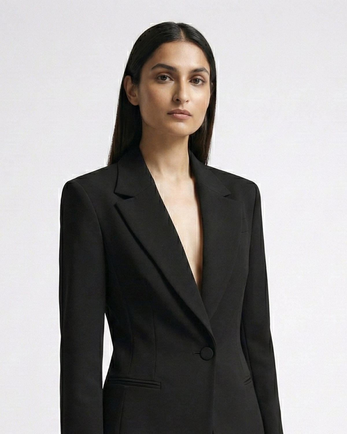 Woman wearing a black suit on a white background