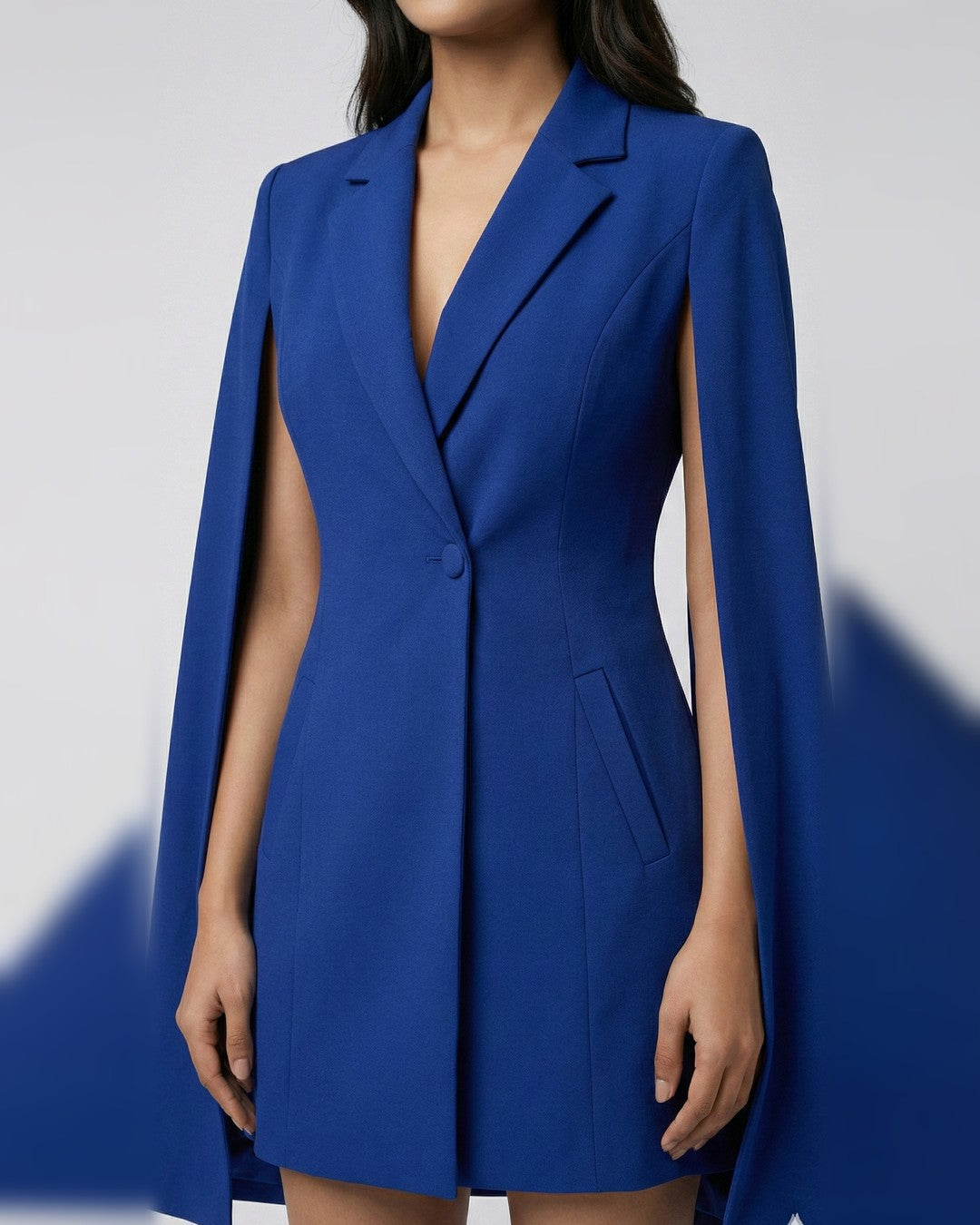 Blue cape blazer dress, close-up of notch lapel, single button, welt pockets and cape sleeves | Beyond Formals