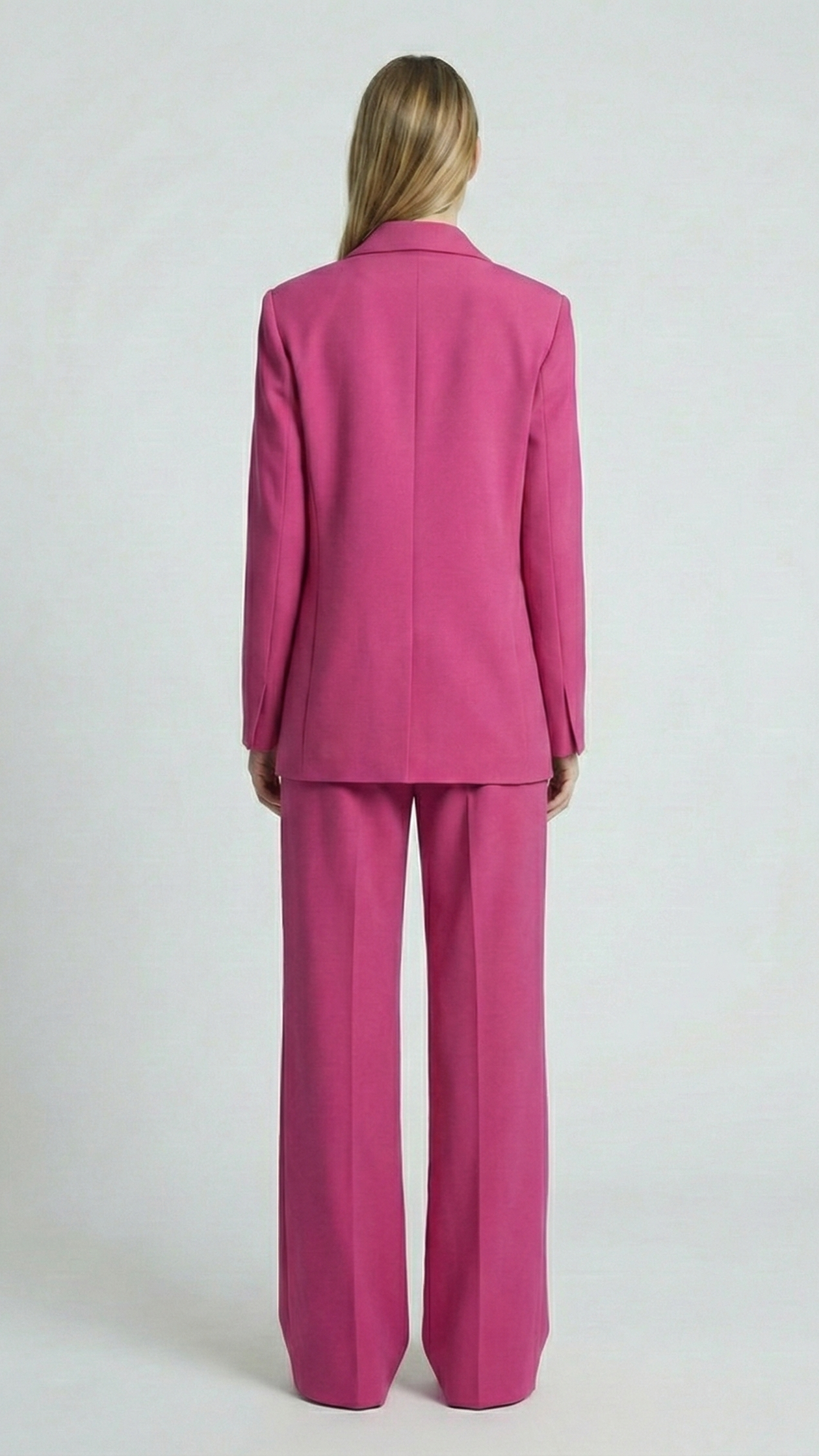 Person wearing a pink suit on a white background
