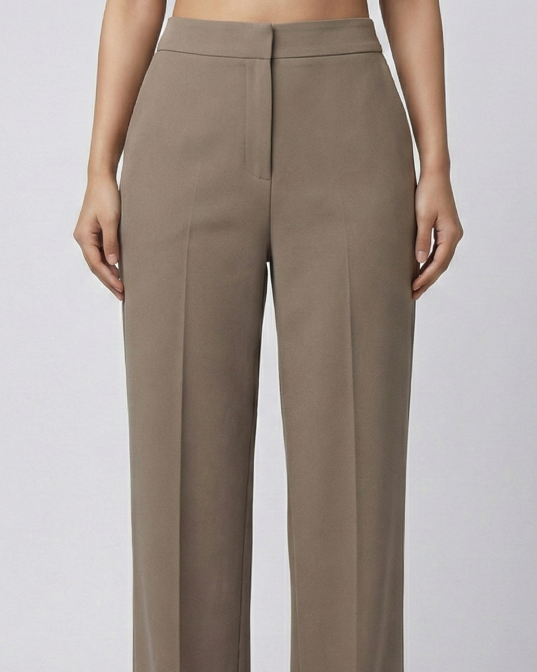 Beige pants worn by a person on a white background