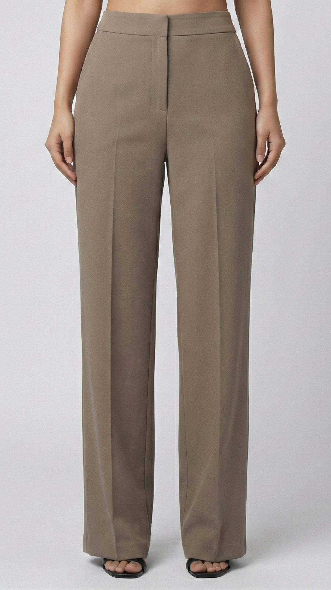 Beige pants worn by a person on a white background