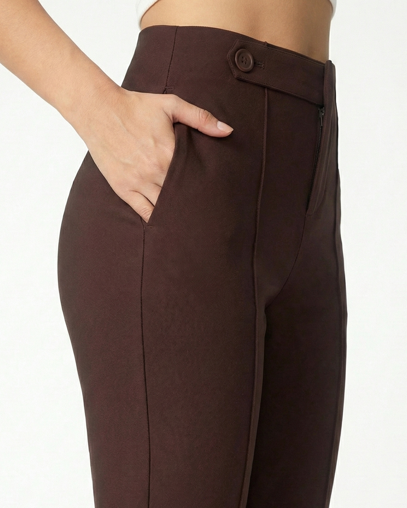 Brown pants worn by a person on a white background
