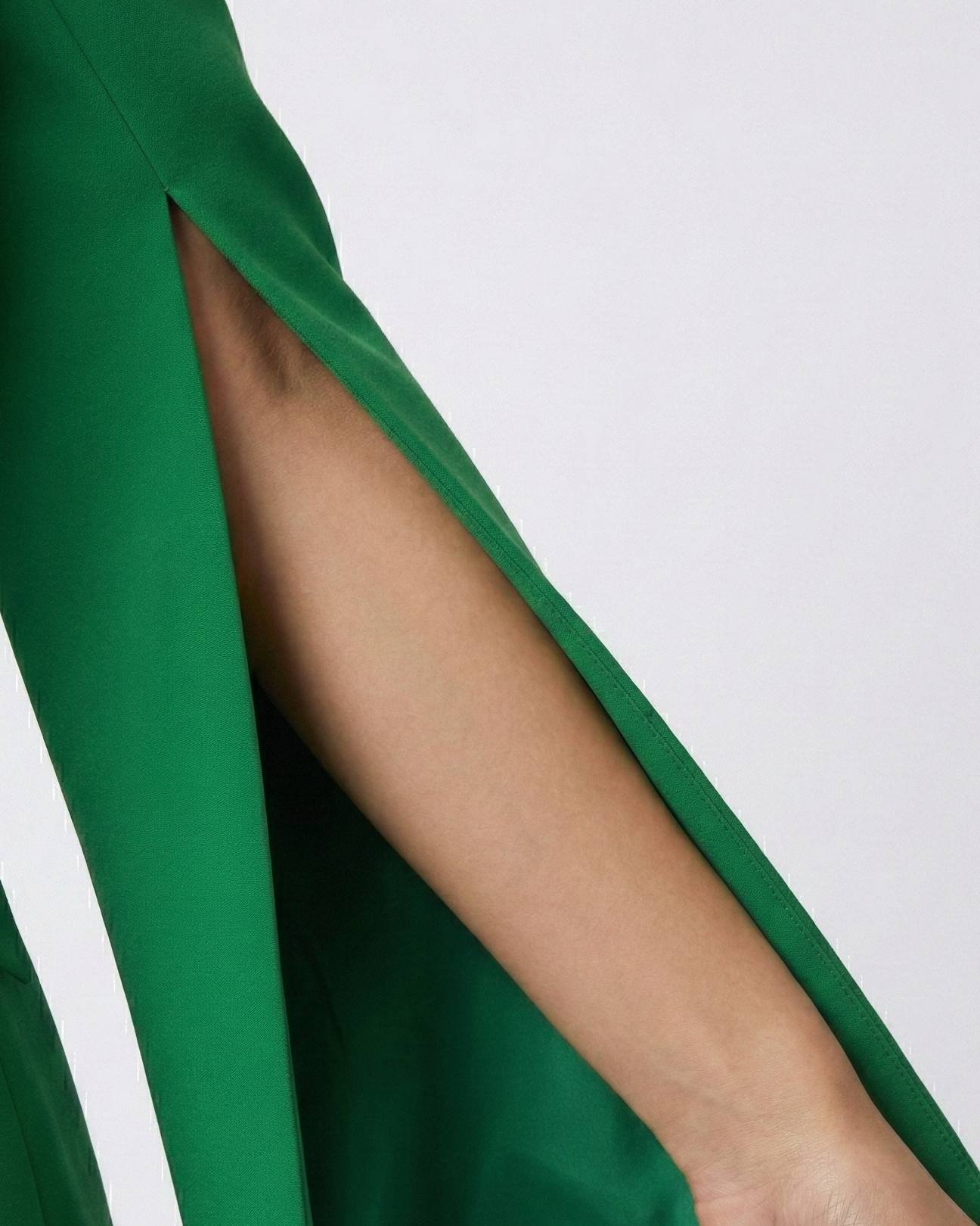 Green outfit with a slit sleeve on a white background