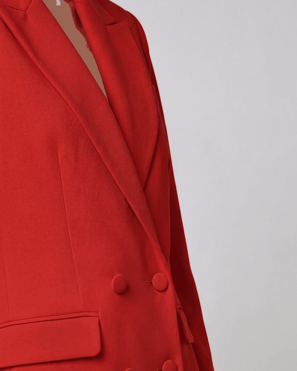 Red blazer, detail of fabric-covered buttons and flap pocket | Beyond Formals