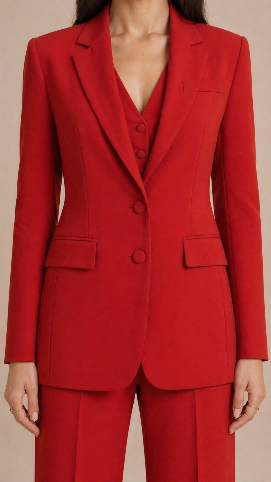 Red suit jacket with matching pants on a beige background