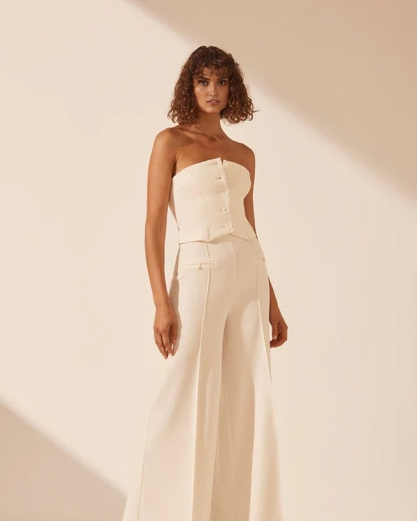 White strapless bustier with structured panels for formal layering.