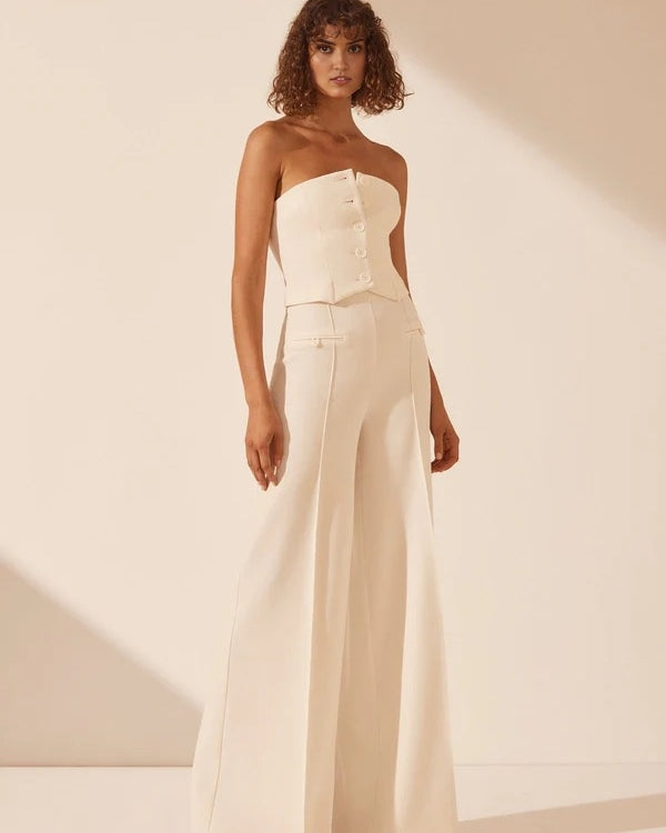 White strapless bustier with structured panels for formal layering.