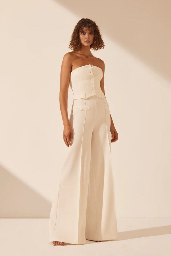 White strapless bustier with structured panels for formal layering.