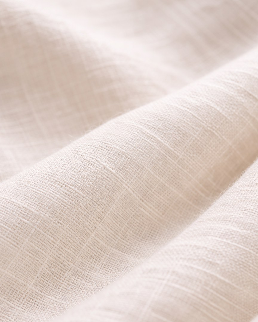 Off-white linen fabric close-up showing natural slub texture | Beyond Formals