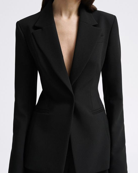Women's black tailored blazer suit set with straight-fit trousers for office wear.