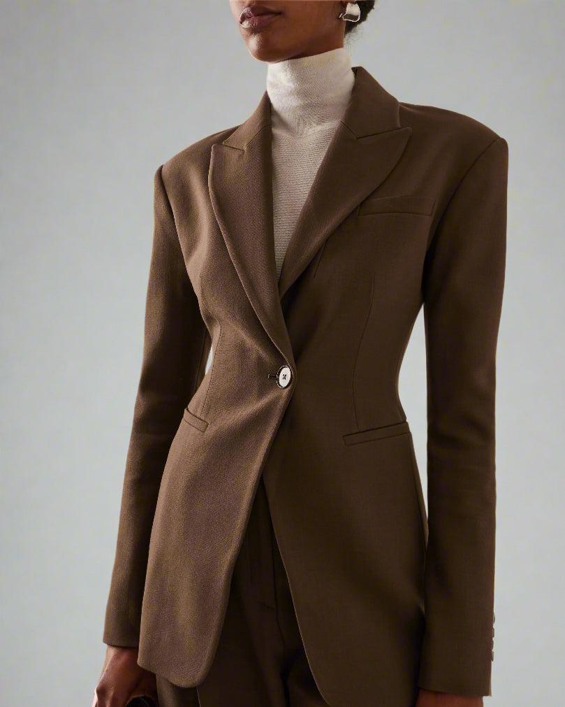 Women's brown fitted blazer with a notched lapel and single closure.