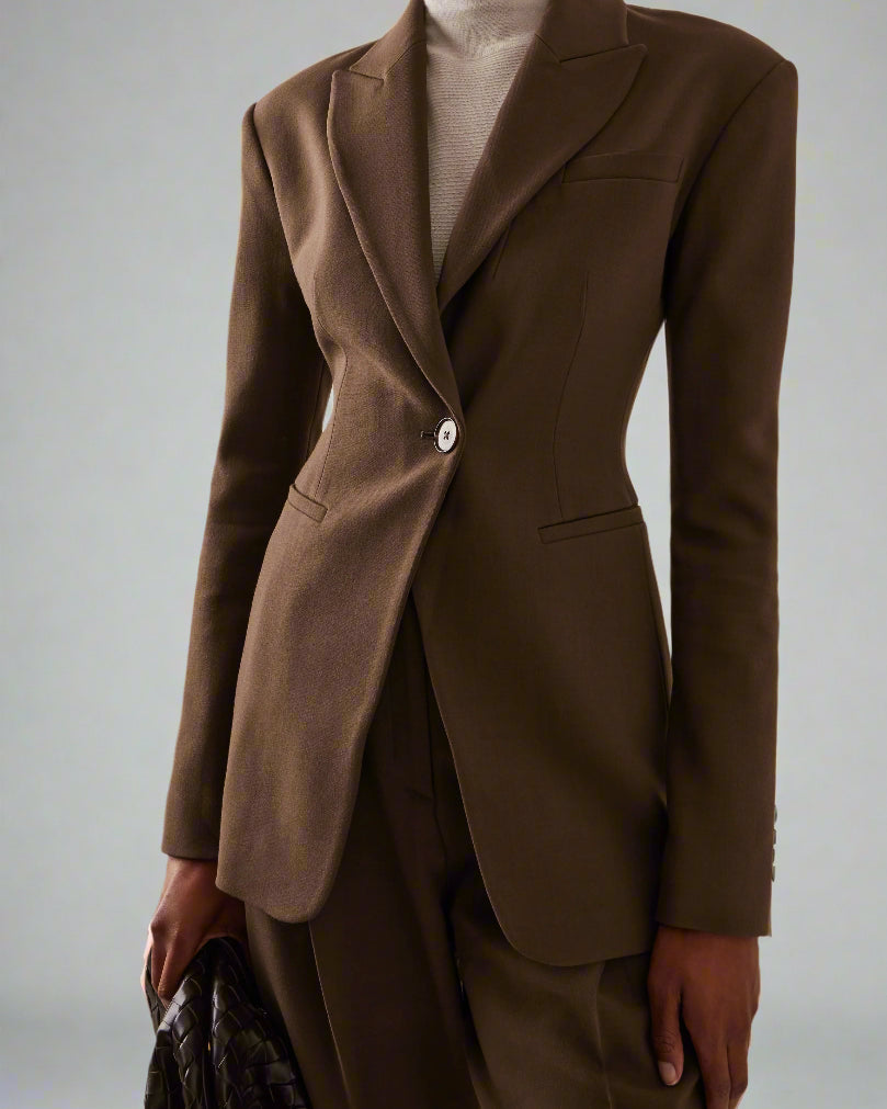 Women's brown fitted blazer with a notched lapel and single closure.
