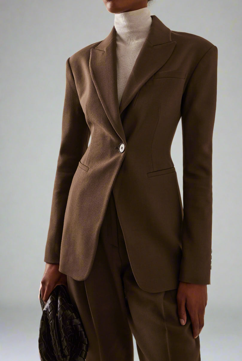Women's brown fitted blazer with a notched lapel and single closure.