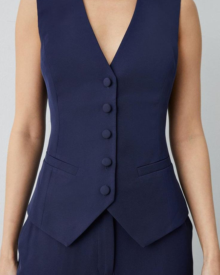 Women's navy blue cotton waistcoat with front pockets, perfect for summer formals.