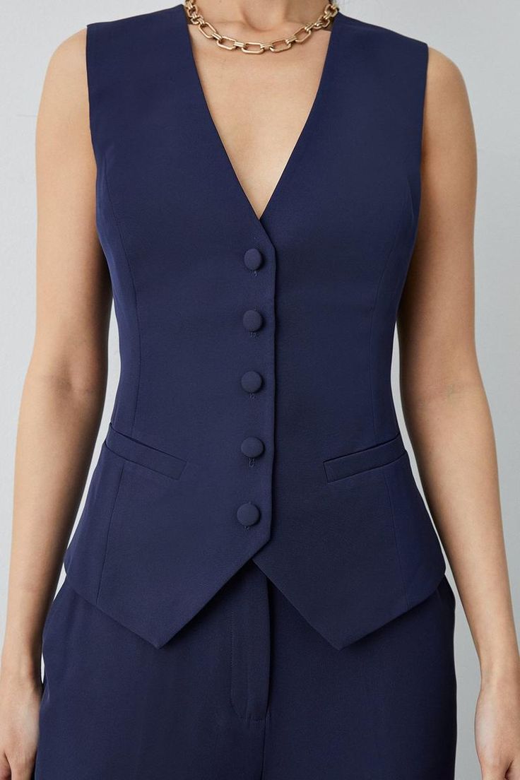 Women's navy blue cotton waistcoat with front pockets, perfect for summer formals.