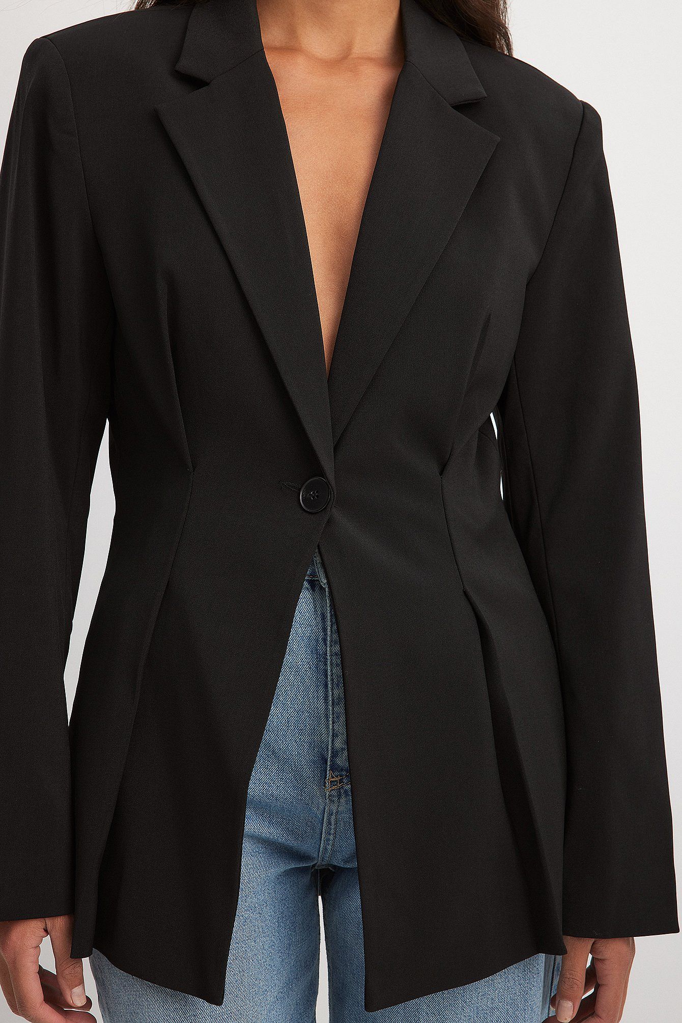 Women's black blazer with padded shoulders and a tailored fit.