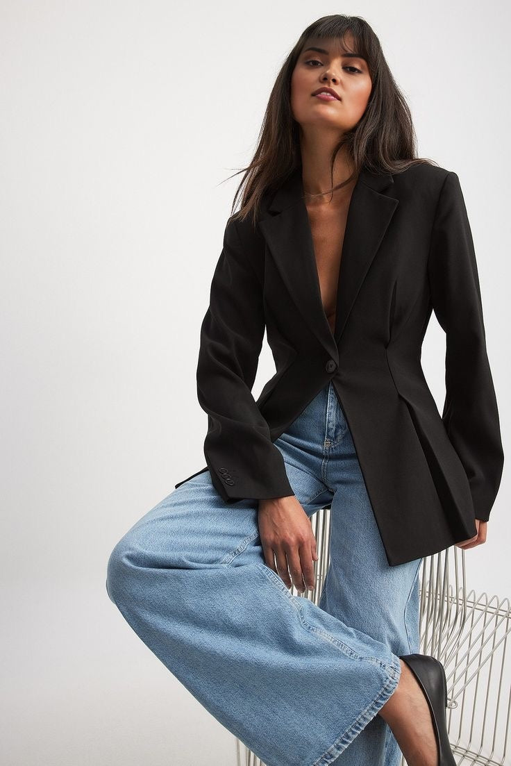 Women's black blazer with padded shoulders and a tailored fit.