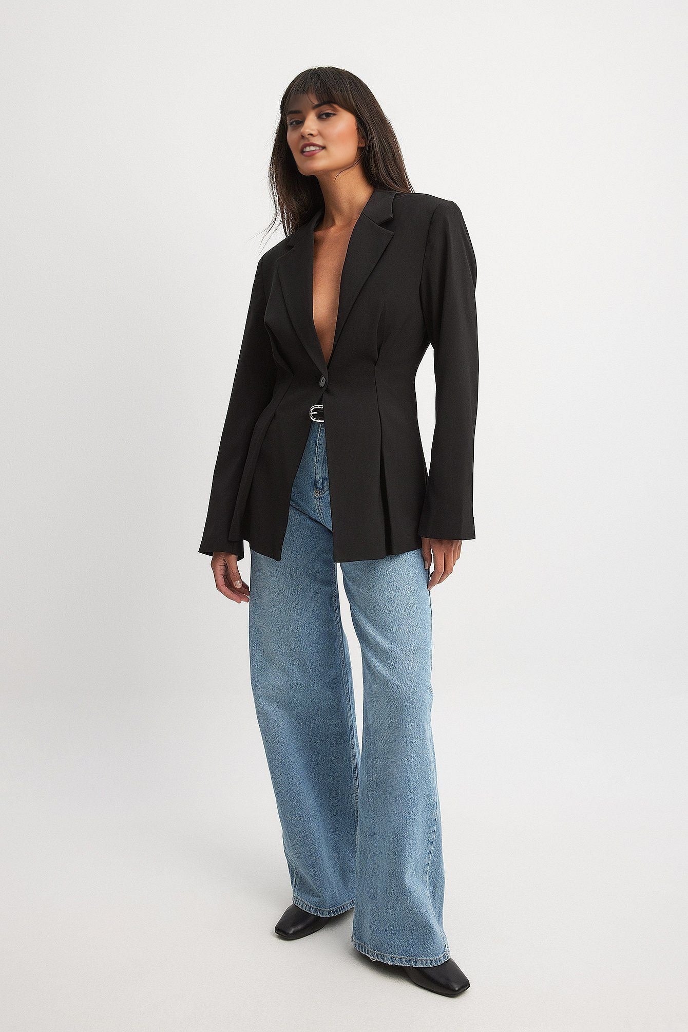 Women's black blazer with padded shoulders and a tailored fit.