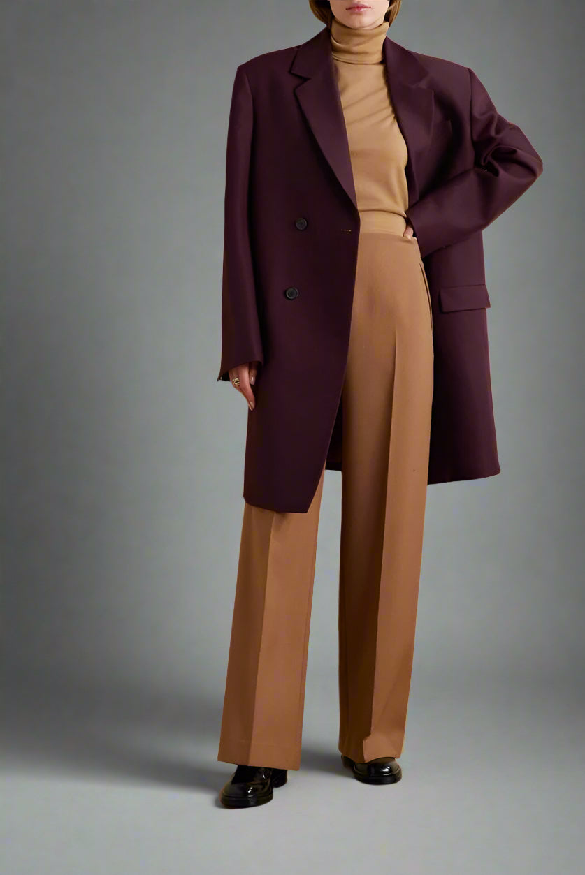 Women's wine color fitted blazer with a notched lapel and button detailing.