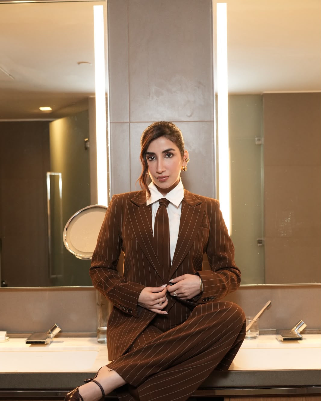 Brown Luxe Pinstripe Two-Piece Suit Set with Tie – lifestyle shot, seated | Beyond Formals