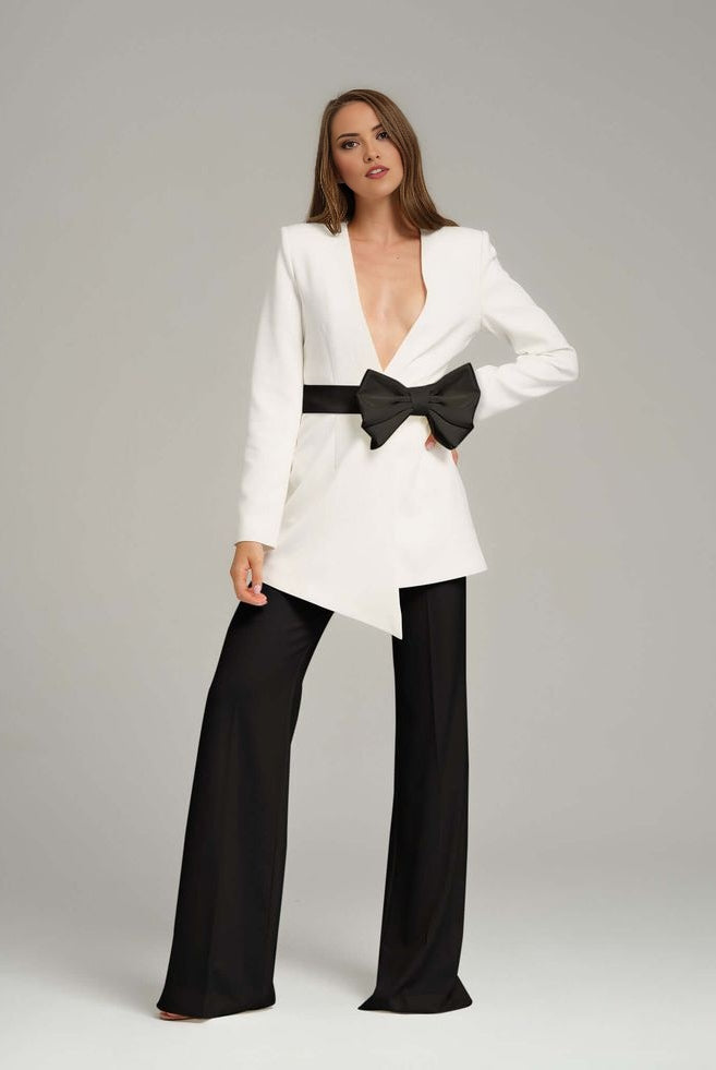 White blazer with black bow for formal business meetings.