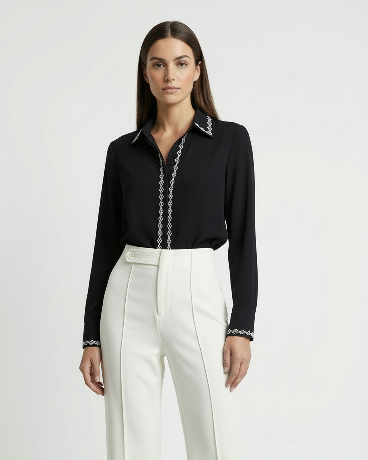 Woman wearing a black shirt and white pants on a white background