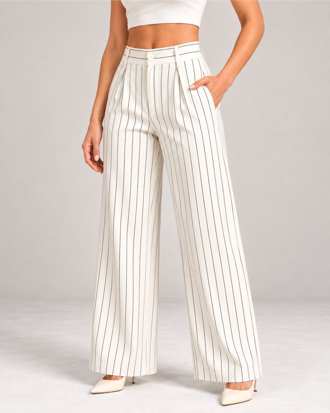 White pinstripe trousers styled with a cream crop top, close-up of waist and pockets | Beyond Formals