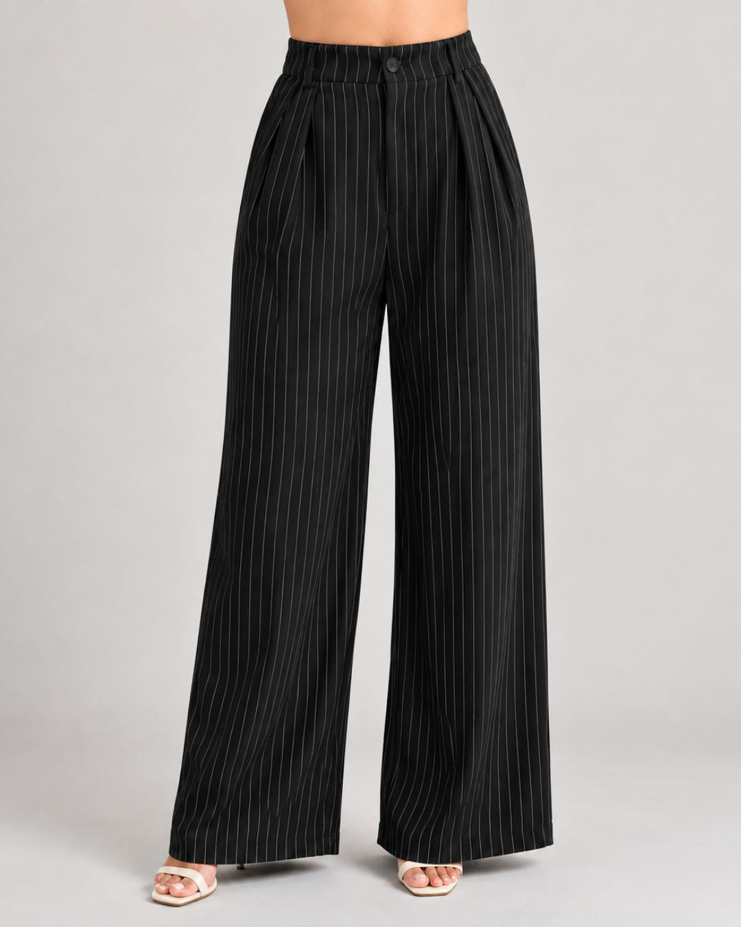 Black pinstripe trousers close-up of button waistband, front pleats and wide leg | Beyond Formals