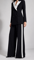 Black and white suit with wide-leg pants on a plain background