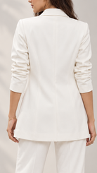 White blazer, back view showing tailored waist seaming and ruched sleeves | Beyond Formals